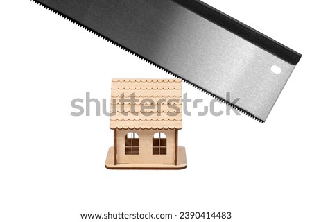 Close-up of a sharp saw for woodworking and cutting a wooden toy house. Conceptual image. Isolated on white background.