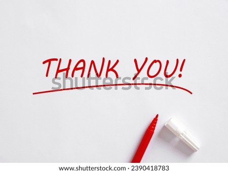 Hand written Thank You message with a red pen on white background. Gratitude concept. Royalty-Free Stock Photo #2390418783