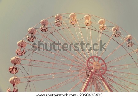 Ferris wheel on the background of blue sky Royalty-Free Stock Photo #2390428405
