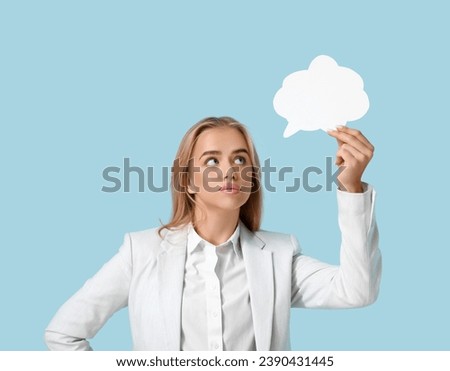 Young businesswoman with speech bubble on blue background. Business idea concept