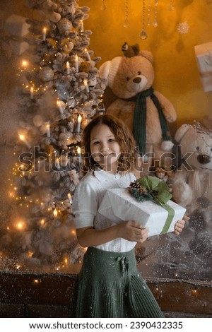 Christmas photo of a smiling girl with gift.