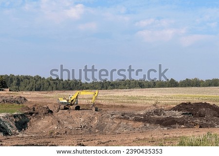 Modern Construction Machinery in Action. View of the mobile crane with a truck. Cable-controlled crane on a truck-type carrier and as self-propelled. Construction site in Europe. Royalty-Free Stock Photo #2390435353