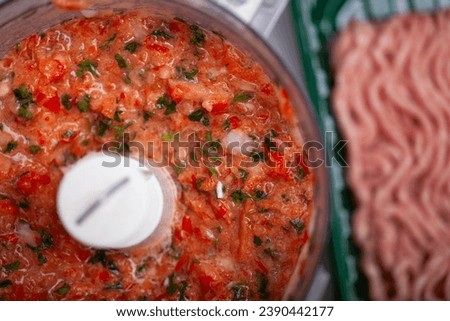 Meat and vegetables for Lahmacun are being processed in a food processor. Royalty-Free Stock Photo #2390442177