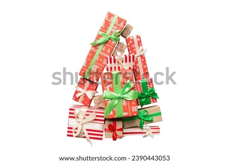 Isolated Christmas tree made of beautifuly wrapped presents on colored background, view from above. New Year gift box minimal concept.