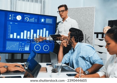 Presentation in office or meeting room with analyst team utilizing BI Fintech to analyze financial data. Businesspeople analyzing BI dashboard power display on TV screen for strategic planning.Prudent Royalty-Free Stock Photo #2390444605
