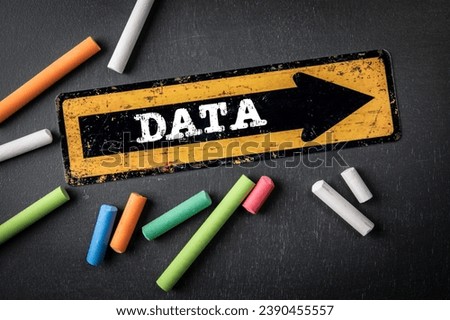 DATA Concept. Direction arrow with text on a dark chalkboard background.