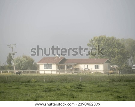 Farm house in morning fog
