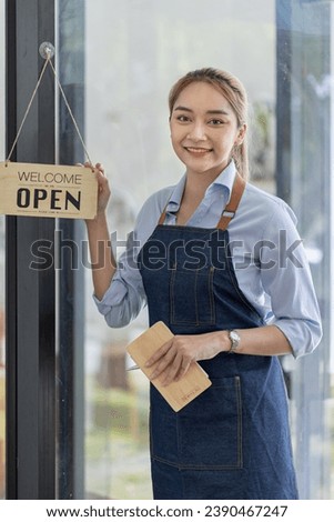 Happy smelling Asian woman owner with open sign broad and ready to service, Small startup business concept.