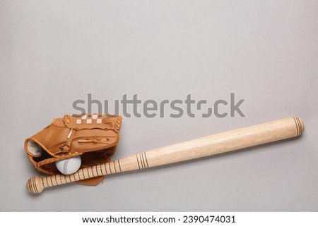 Baseball glove, bat and ball on light grey background, flat lay. Space for text