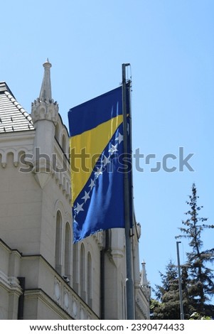 Bosnian Flag in Sarajevo witj Architecture Royalty-Free Stock Photo #2390474433