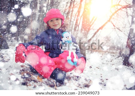 Girl in the park winter snow walk