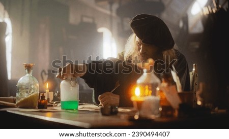 Medieval Representation: An Old Apothecary Experimenting with Chemistry and Making a New Medicine in his Laboratory. Experienced Renaissance Doctor Inventing a Healing Elixir to Cure Diseases Royalty-Free Stock Photo #2390494407