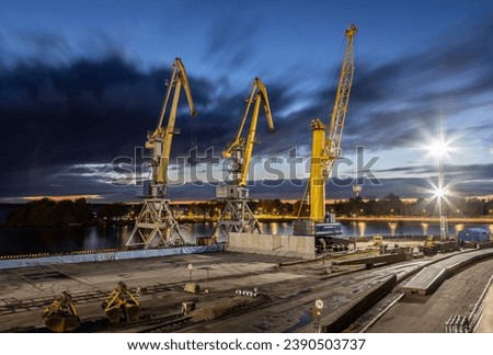 Evening in the seaport of Vyborg. Port cranes Royalty-Free Stock Photo #2390503737