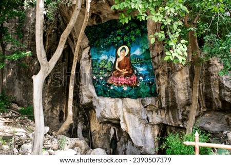 Architecture ancient design of frescoes mural painting drawing buddha image on antique cavern wall for thai people travelers travel visit in Wat Tham Nam or Water Cave Temple in Ratchaburi, Thailand