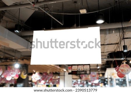 A well-positioned ceiling-mounted sign in a store, effectively guiding and informing shoppers about store offerings.
