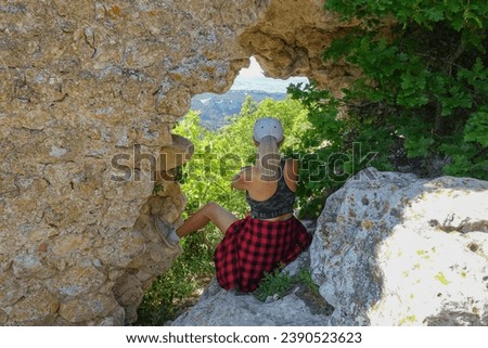 Mangup-Kale cave city, sunny day. A girl on the background of a mountain view from the ancient cave city of Mangup-Kale in the Republic of Crimea, Russia. Bakhchisarai
