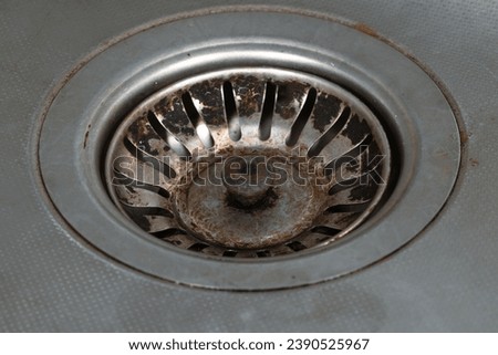 Hole in a kitchen metal sink. Rusty sink drain hole