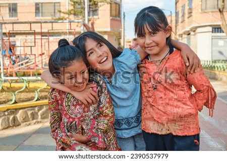 three latin girl friends hugging each other on a sunny summer day in latin america bolivia