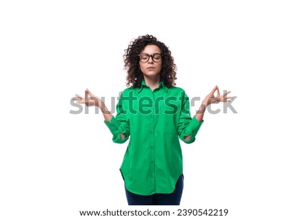 brunette young caucasian lady with curly hair dressed in a green shirt is waiting for the fulfillment of a wish