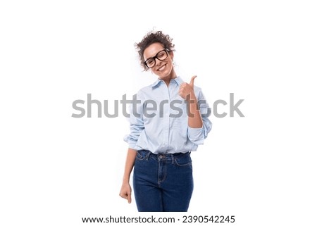 smart stylish young brunette curly young employee of the company woman dressed in a light blue shirt on the background with copy space