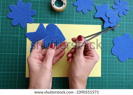 Closeup cardboard with hobby material and women hands  working handmade  Royalty-Free Stock Photo #2390551573