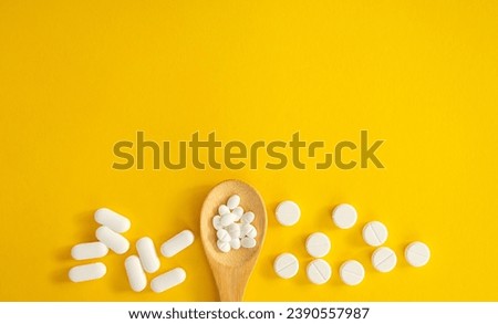 woman holding several vitamin pills and supplements in her hands