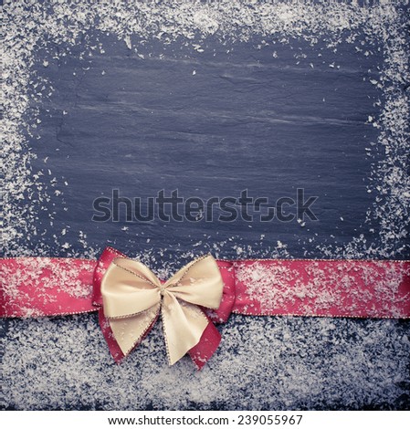 Christmas background with a red ribbon and snow with copy space. christmas frame