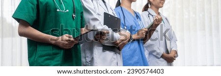 Confident and professional team of medical staff stand in line together as healthcare service and doctor leadership at hospital background. Teamwork lead to successful medical treatment.Panorama Rigid