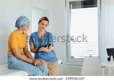Teenage oncology patient talking with doctor. Oncologist treating teen girl with cancer and provide emotional support, helping her with anxiety and depression. Royalty-Free Stock Photo #2390581107