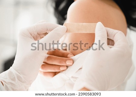 Close up cropped shot of vaccination concept. Doctor making injection against coronavirus Covid 19 to female patient at the hospital to stop pandemic.