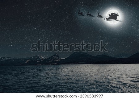 Santa Claus flies against the background of the moon on Christmas Eve