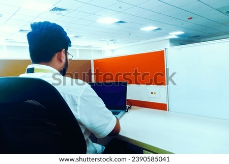 Businessman working on a laptop in a modern office. Business concept. Royalty-Free Stock Photo #2390585041