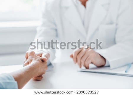 Close up of doctor and patient handshaking. Successful treatment. Recuperation and healing. Fighting against cancer. Hope and psychological aid assistance Royalty-Free Stock Photo #2390593529