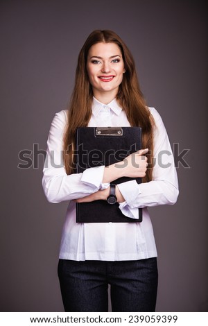 Picture of a young attractive businesswoman with folder