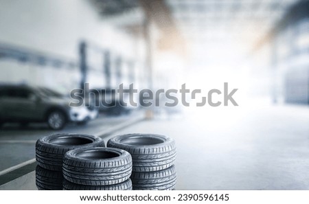 Car tires pile in a car service center or auto tire shop with copy space , Car tire shop and maintenance service concept Royalty-Free Stock Photo #2390596145