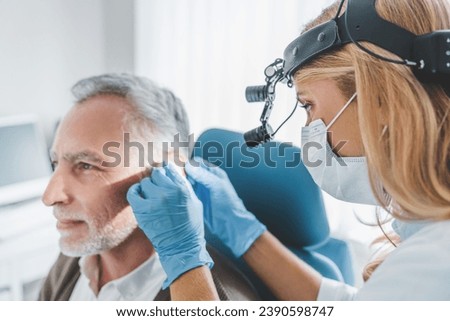 Mature patient with hearing problem visiting doctor otolaryngologist. Deafness, hear loss problems issues treatment prevention. Barotrauma otitis Royalty-Free Stock Photo #2390598747