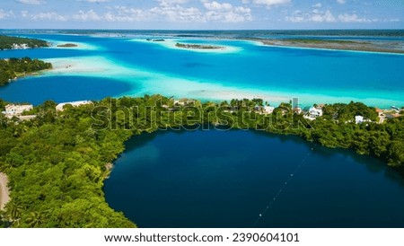 drone revealing cenote in Bacalar Mexico with 7 colours lagoon Quintana Roo Mexican resort beach town travel holiday destination  Royalty-Free Stock Photo #2390604101