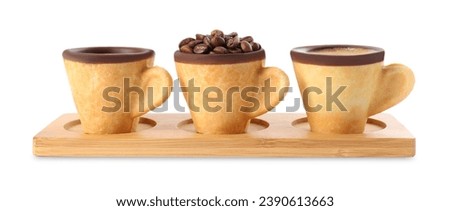 Edible biscuit cups with espresso, coffee beans and empty one on white background