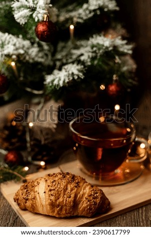 Croissant and tea. Pastries for Christmas. Fast food during the winter holidays. High quality photo