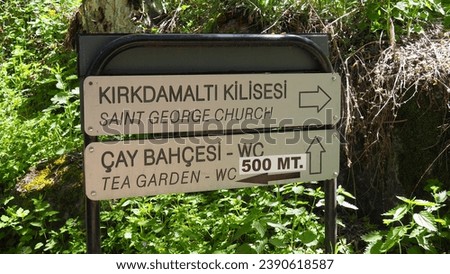 A sign board showing directions to the tourist area of Saint George's Church and Tea Gardens in Cappadocia, Türkiye