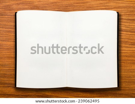 open book on wooden table 