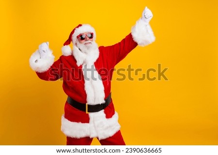 Portrait of delighted elderly santa raise fists empty space new year eve offer ad isolated on yellow color background