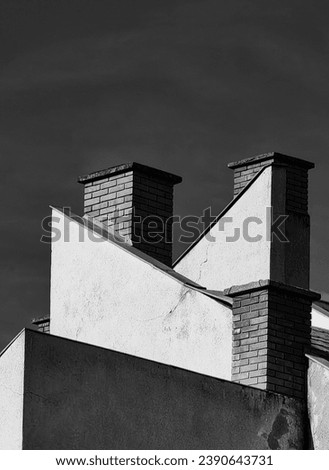Three chmineys, brick work. Abstract point of view. Imagination. Black and white , monochrome. Dark sky.