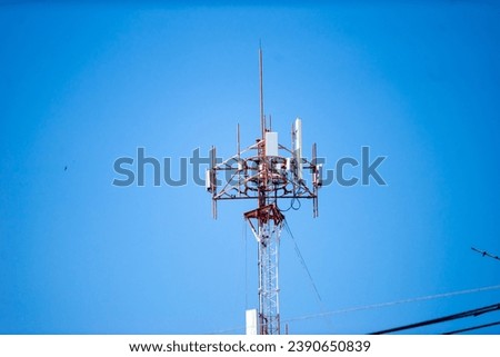 Telecommunication tower with blue sky and white clouds, technology background.     