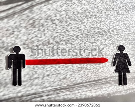 The concept of divorce, quarrels, and separation of a couple. Paper black figurines of a man and a woman separated by red line. Abstract background, texture