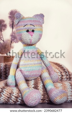Knitted striped toy sitting on the table