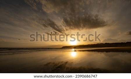 Surf at sunset last day of 2022 Royalty-Free Stock Photo #2390686747