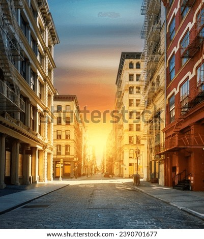 Empty streets with no people in the SoHo neighborhood of New York City with colorful sunset background