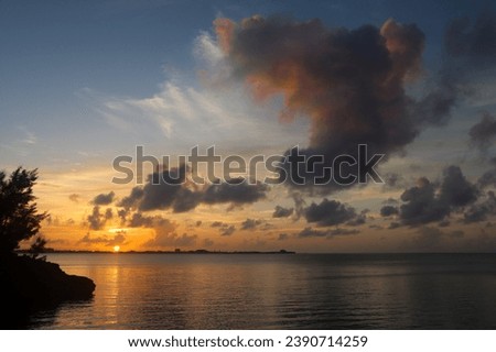 `Dramatic Colourful Sunset Sky over Atlantic Ocean. Clouds with Sunrays. Cloudscape Nature Background Royalty-Free Stock Photo #2390714259
