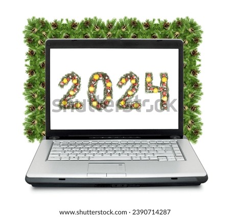 Christmas laptop and 2024 number made by christmas tree branches isolated on white background